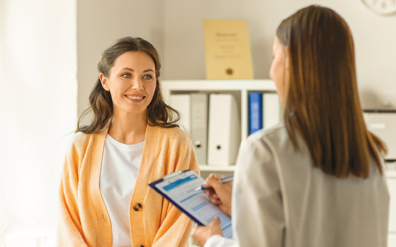 Woman smiles at her doctor while in doctor's office