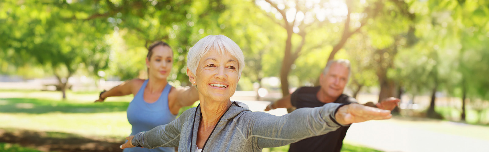 a fitness group stretches in the park
