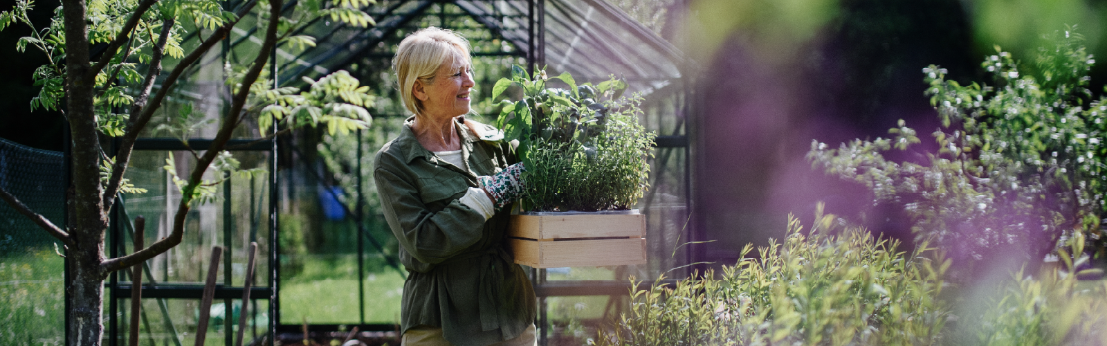 A woman stands outside in her garden
