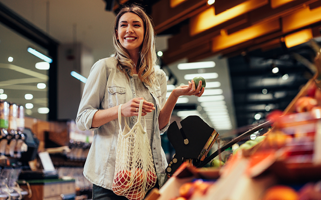 Woman smiling while shopping for produce