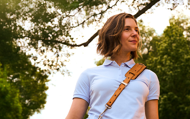 Postal worker carrying bag smiling