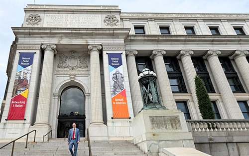 David Hakanson walking down the steps of Postal museum